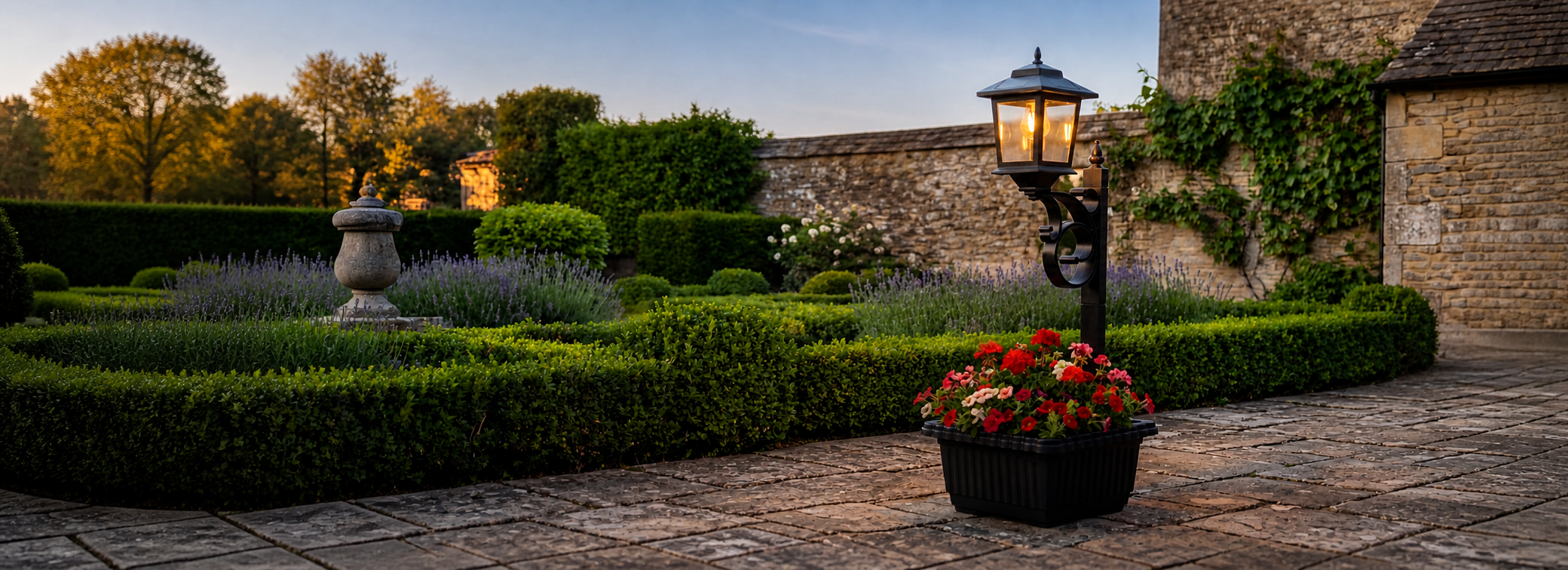 HOODINK solar planter lamp lighting a garden at dusk